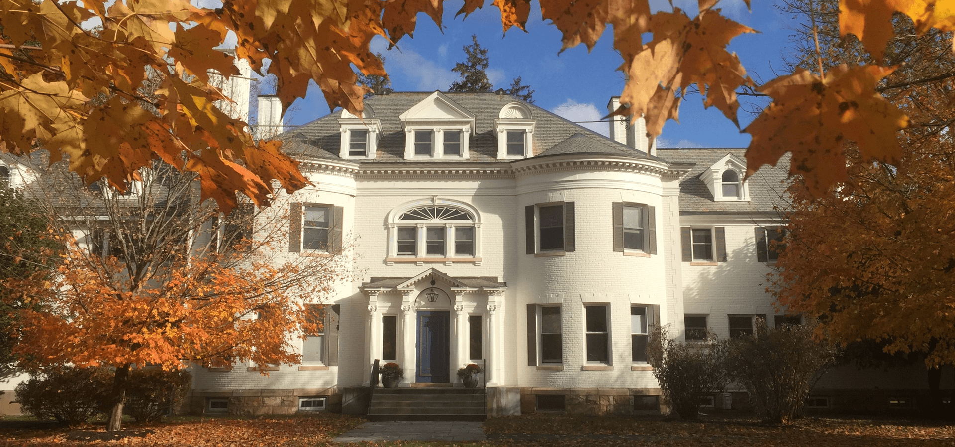Historic house on the campus of Austen Riggs Center among fall foliage