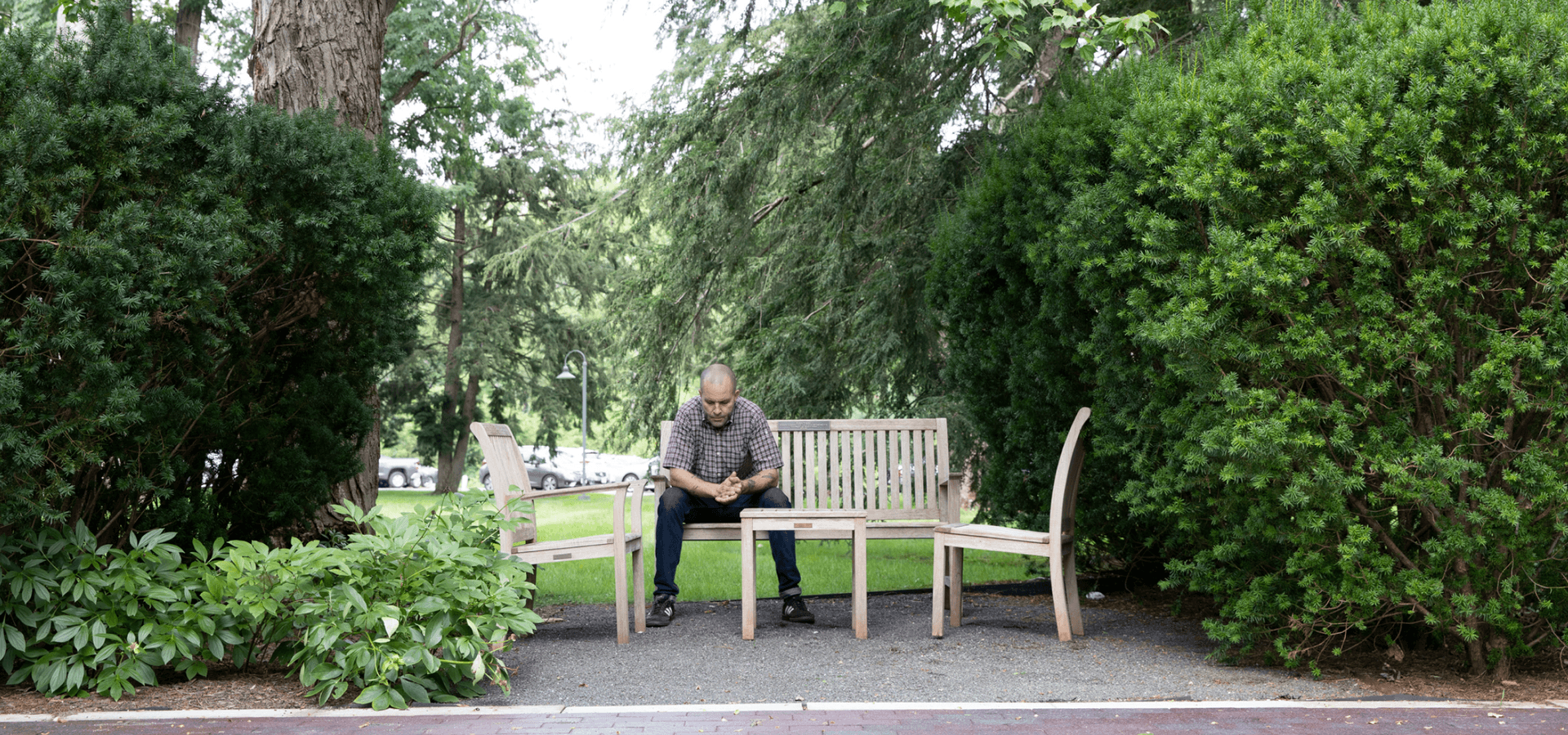 Man sitting on park bench contemplating treatment
